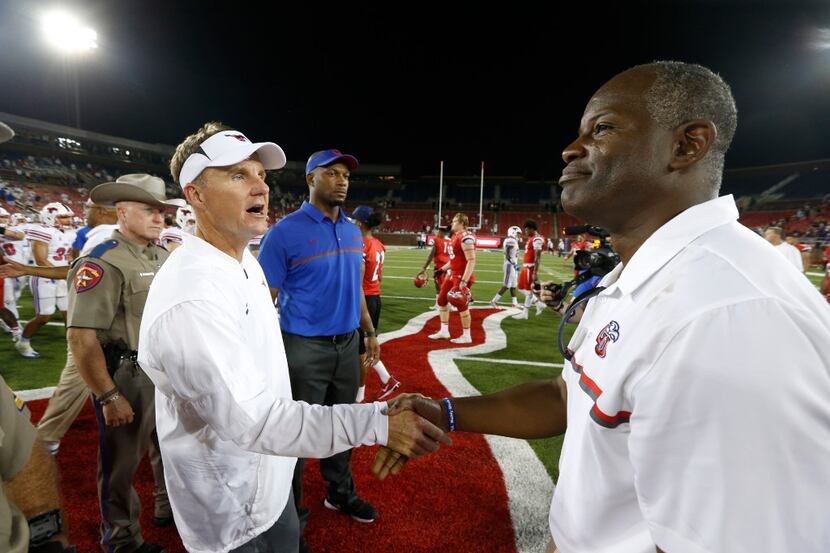 Southern Methodist Mustangs head coach Chad Morris (left) and Liberty Flames head coach...