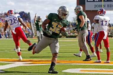 Baylor running back Shock Linwood (32) scores a touchdown against Kansas during the second...