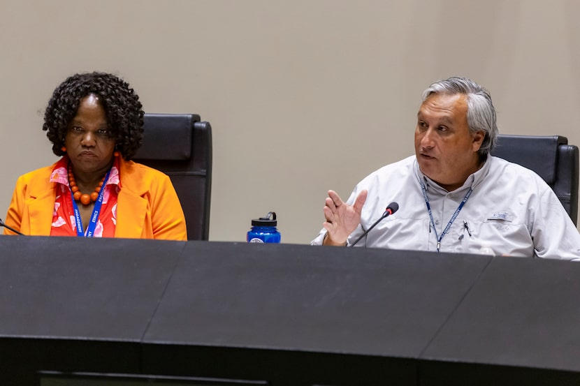 Tonya McClary, director of Dallas' Office of Community Police Oversight, left, looks on as...