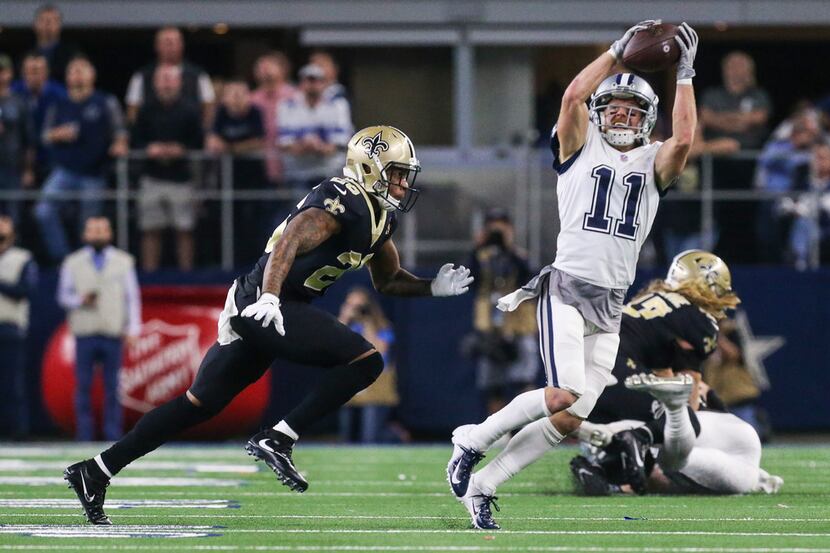 Dallas Cowboys wide receiver Cole Beasley (11) receives a pass over New Orleans Saints...