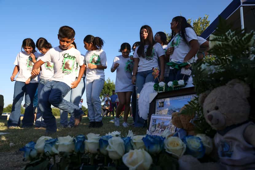Giovani Gonzalez,10, dances near his cousin Xavier’s grave with his cousins and friends,...
