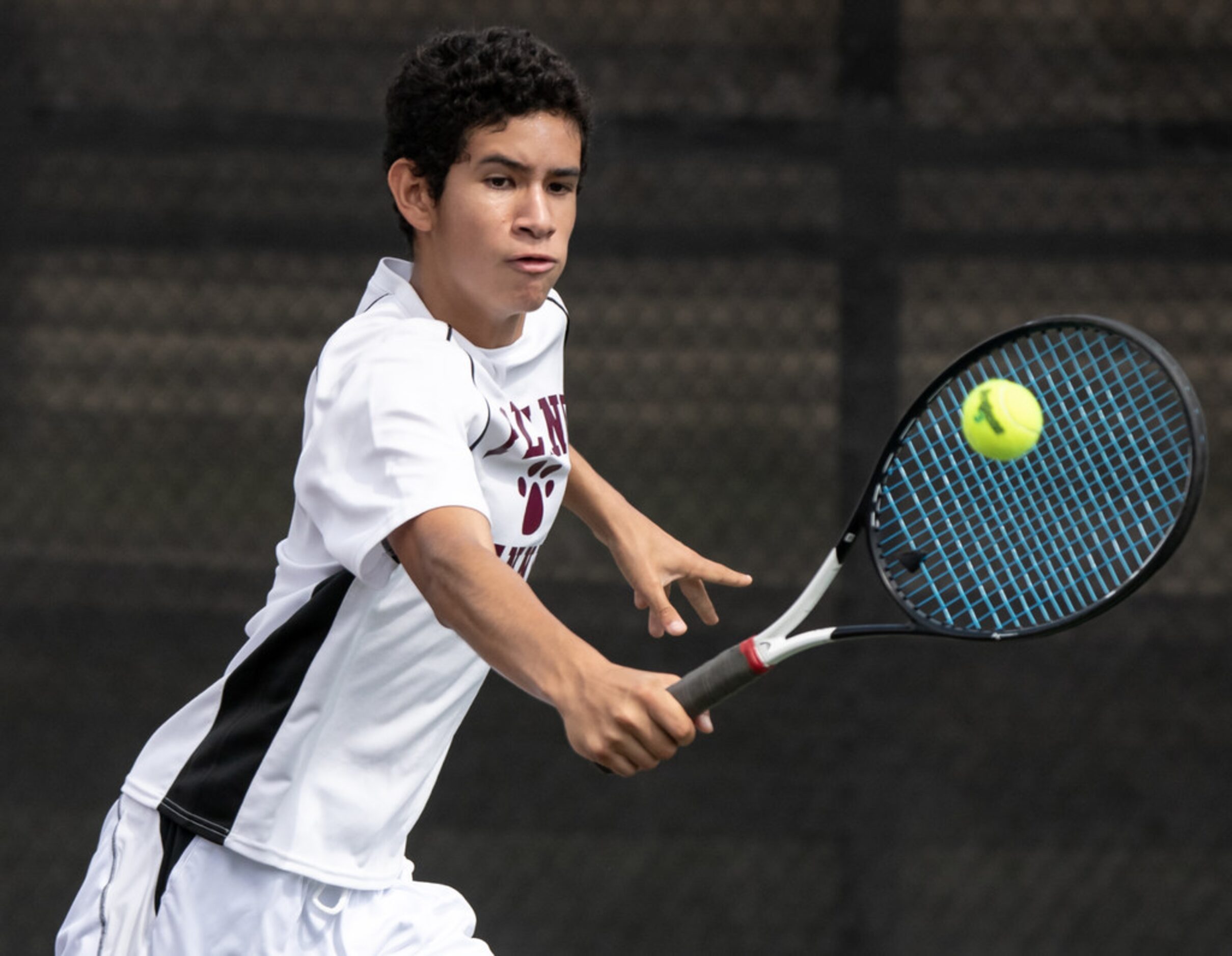 Plano's Herman Aguirre returns the ball in a doubles match with teammate Edward Shteyn in a...