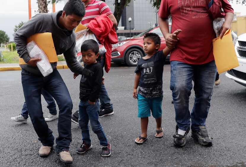Young immigrants arrive with their parents at the Catholic Charities Rio Grande Valley after...