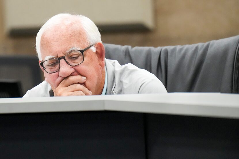 Board member David Kitner watches body camera footage from a Dallas police shootout during a...