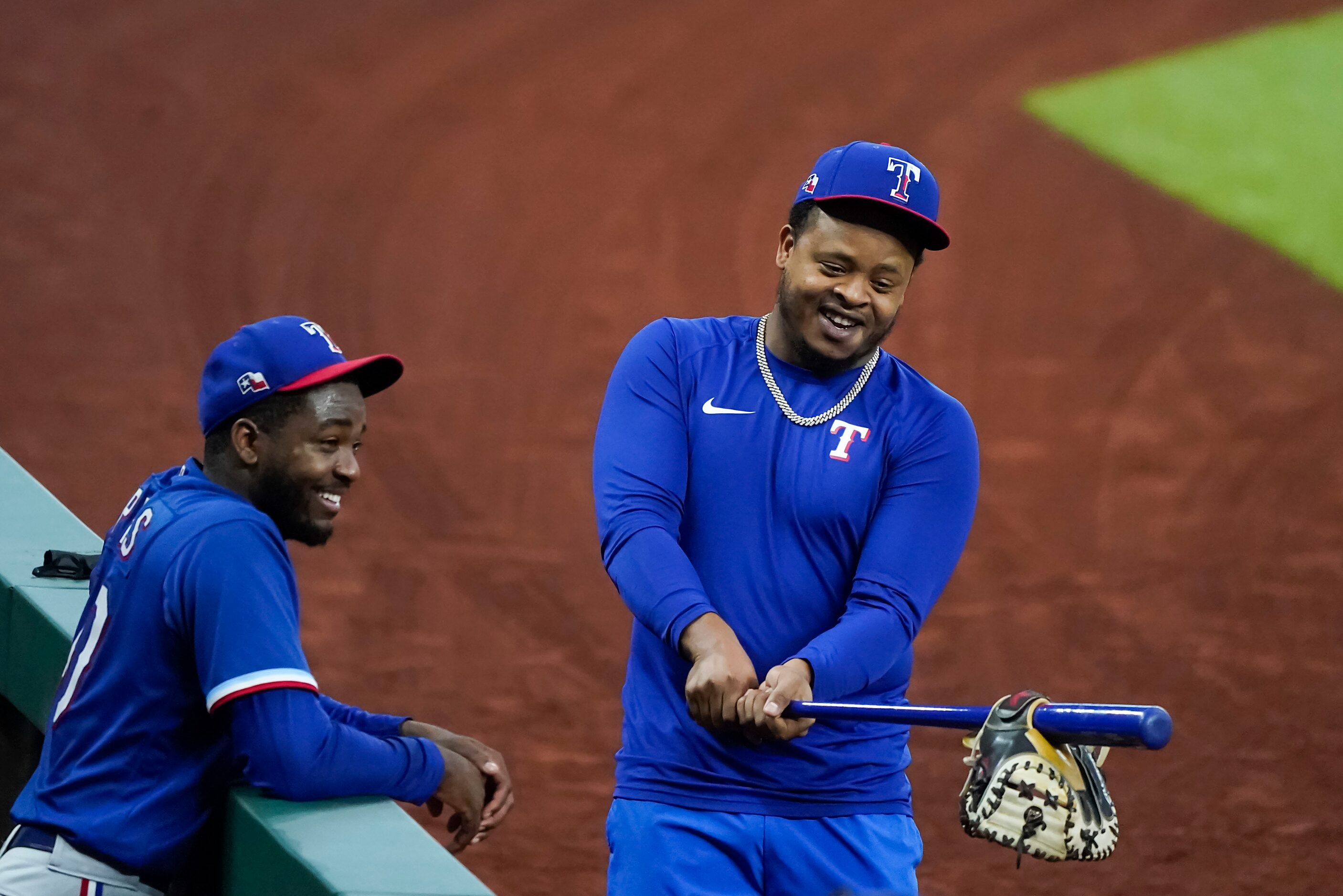 Texas Rangers pitcher Alex Speas (left) laughs with teammate Edinson Vólquez  between...