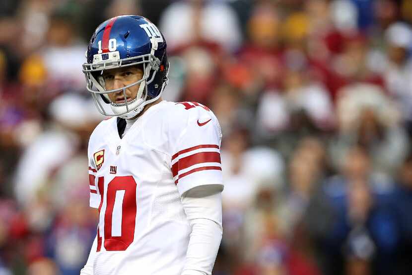 LANDOVER, MD - JANUARY 01: Quarterback Eli Manning (#10) of the New York Giants looks on...
