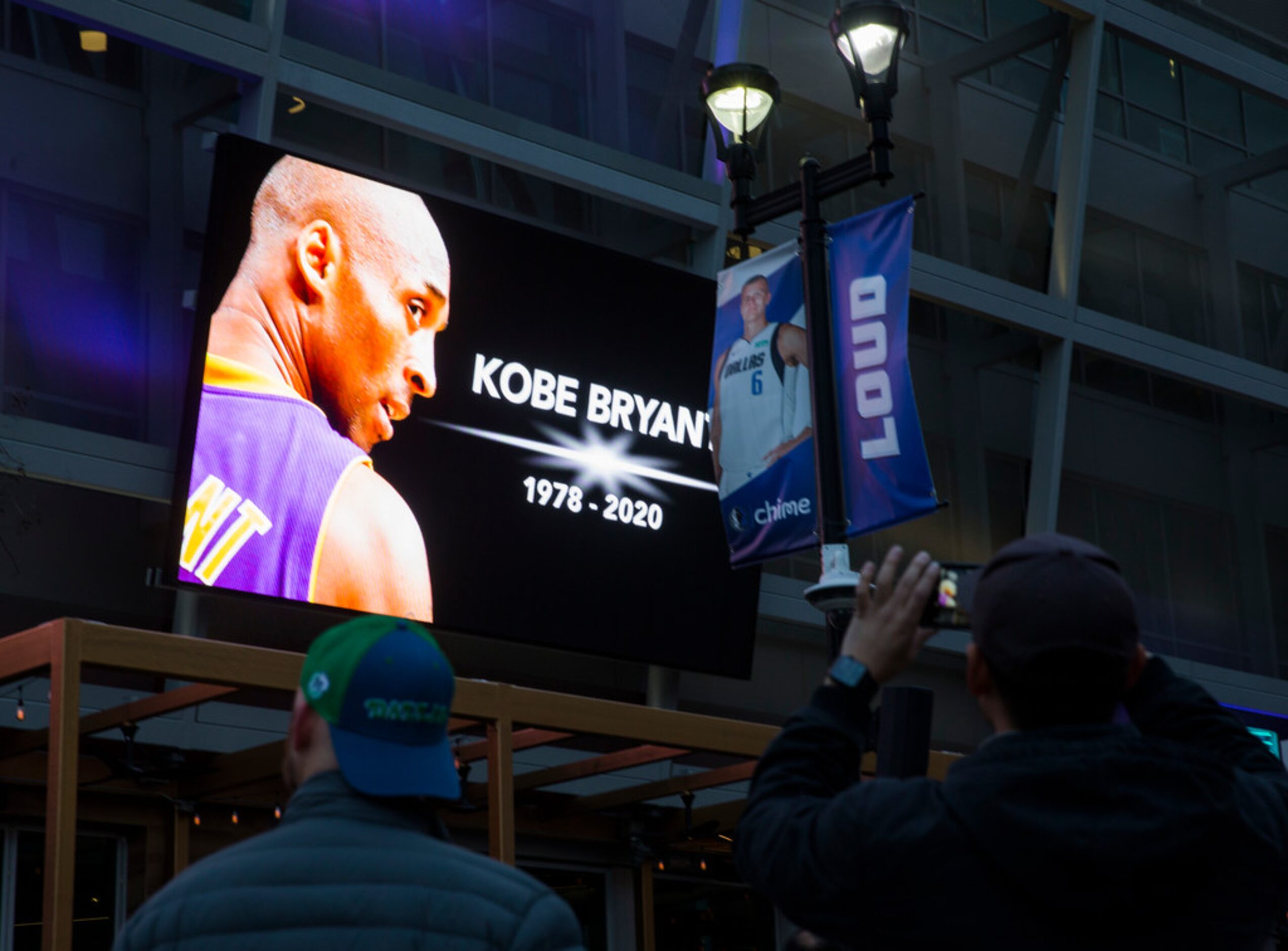 Large screens display a tribute to former Los Angeles Laker Kobe Bryant and his daughter,...