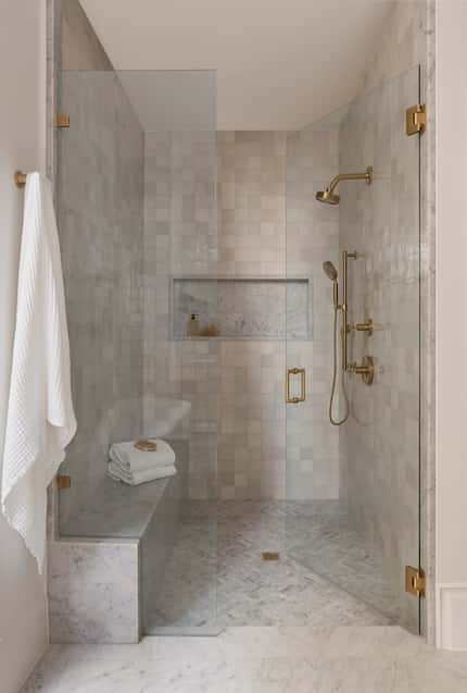 Designer Ashleigh Graber designed this soothing primary bathroom shower with a  marble slab...