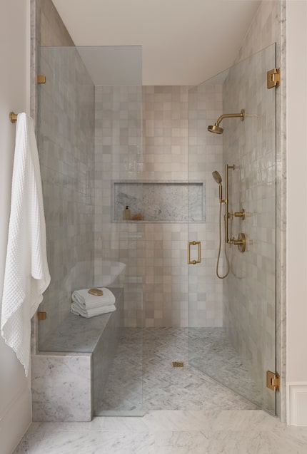 Designer Ashleigh Graber designed this soothing primary bathroom shower with a  marble slab...