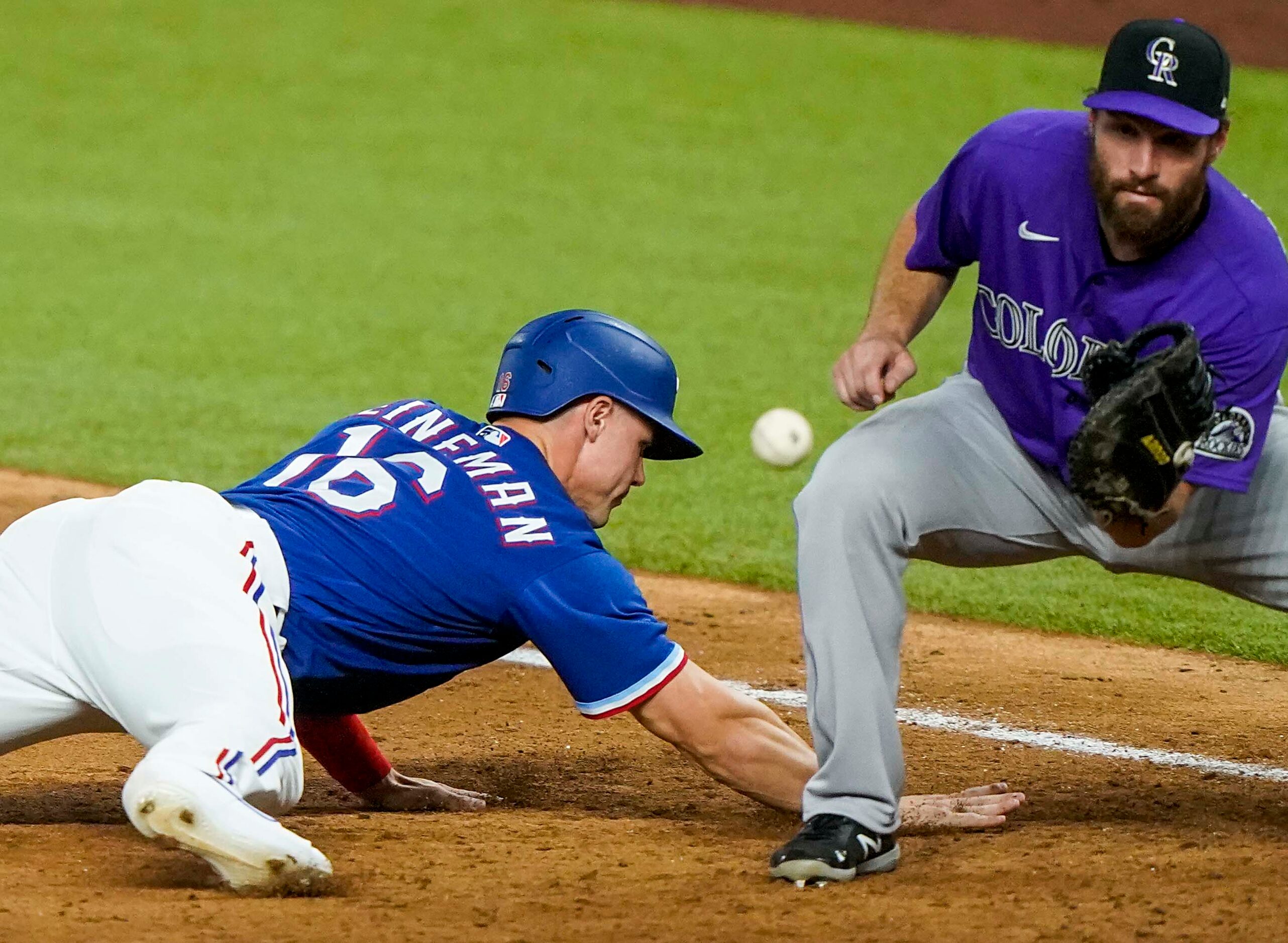 Texas Rangers outfielder Scott Heineman gets back to first base on a pickoff attempt ahead...