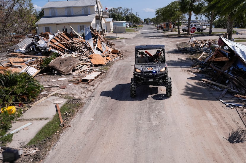 Law enforcement officers from the Florida Fish Wildlife and Conservation Commission drive...