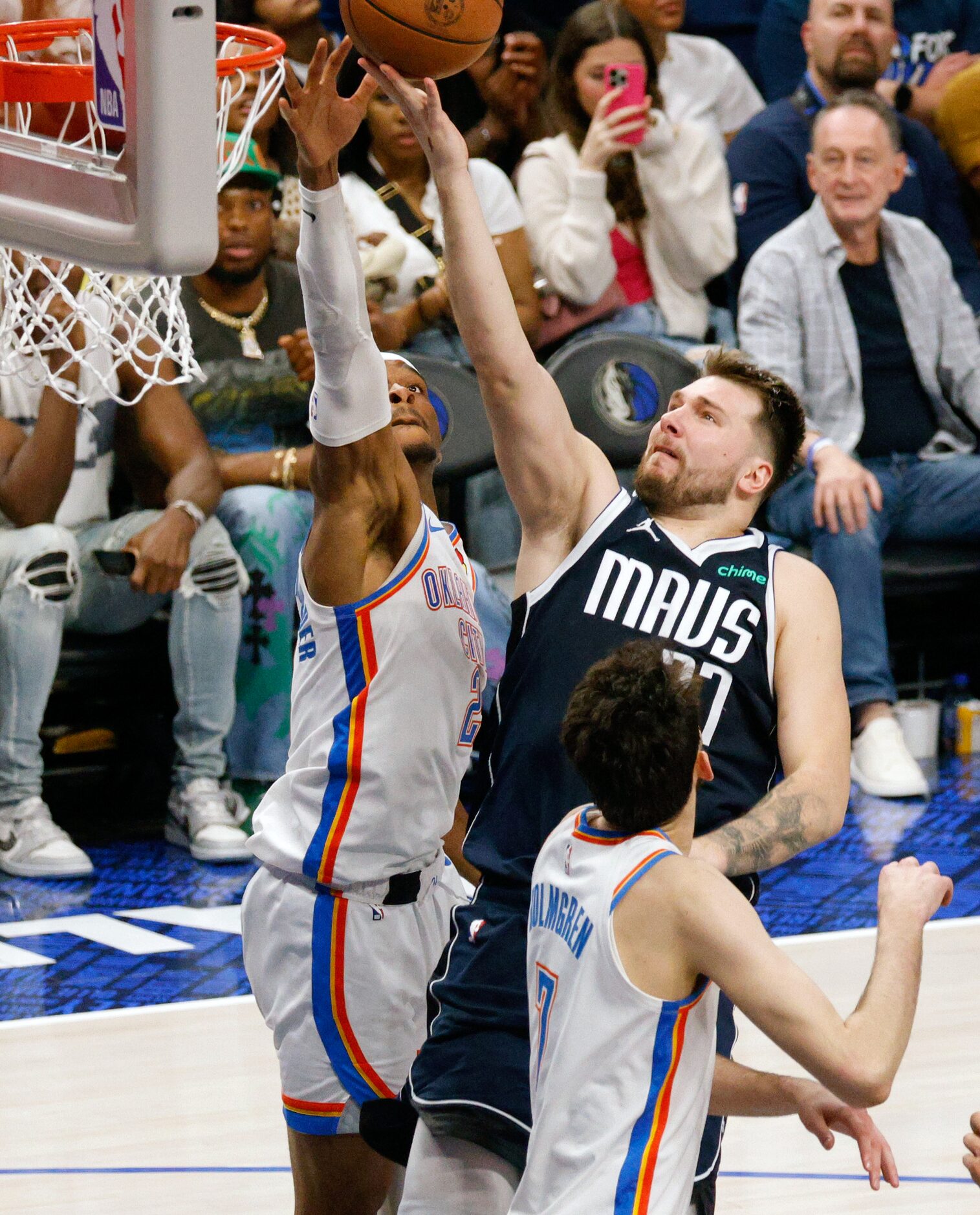 Dallas Mavericks guard Luka Doncic (77) shoots over Oklahoma City Thunder guard Shai...