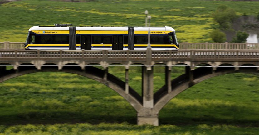 The DART Downtown-to-Oak Cliff Streetcar crosses the Trinity River bottoms on the Houston...