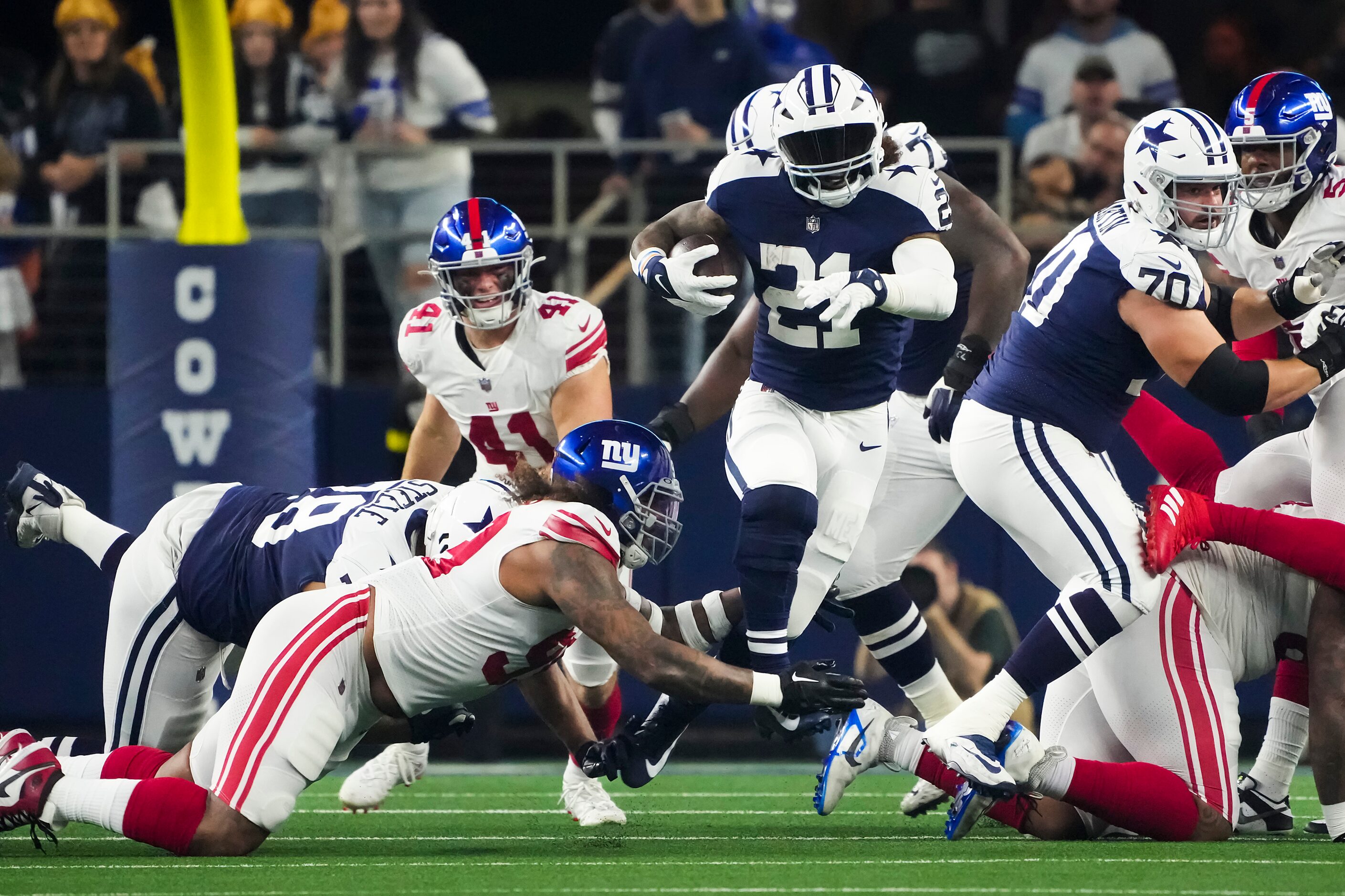 Dallas Cowboys running back Ezekiel Elliott (21) breaks through the New York Giants defends...