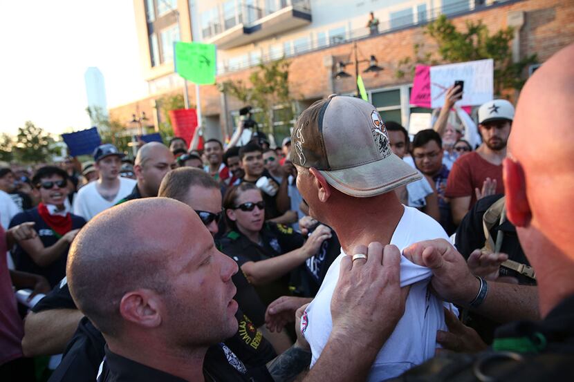  Dallas Police remove a Donald Trump supporter from a crowd of protestors during Trump's...