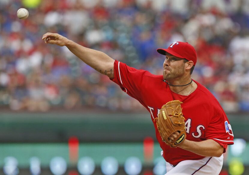 Texas pitcher Colby Lewis throws a first-inning pitch during the Chicago White Sox vs. the...