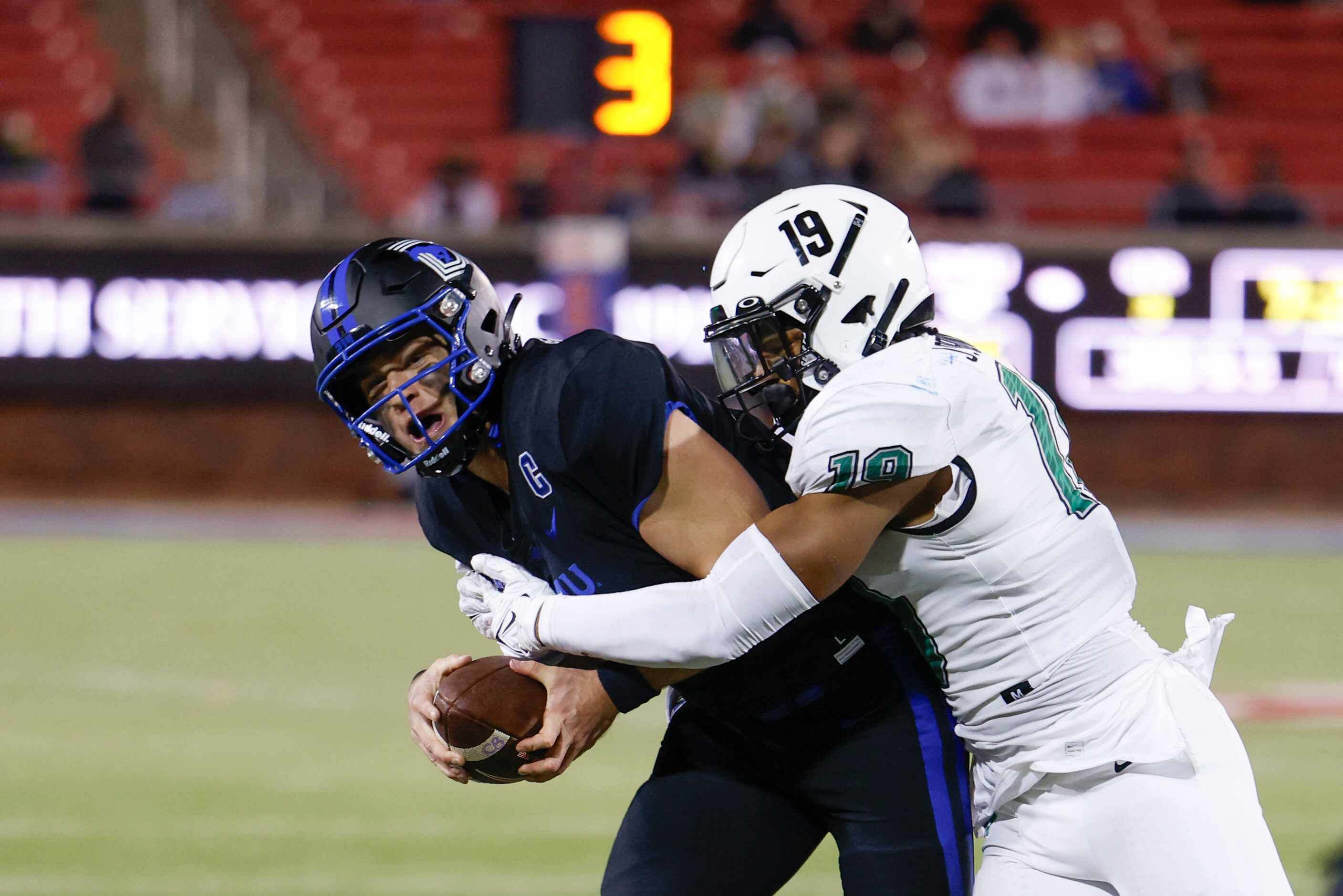 Southern Methodist Mustangs quarterback Preston Stone (left) gets tackled by linebacker...