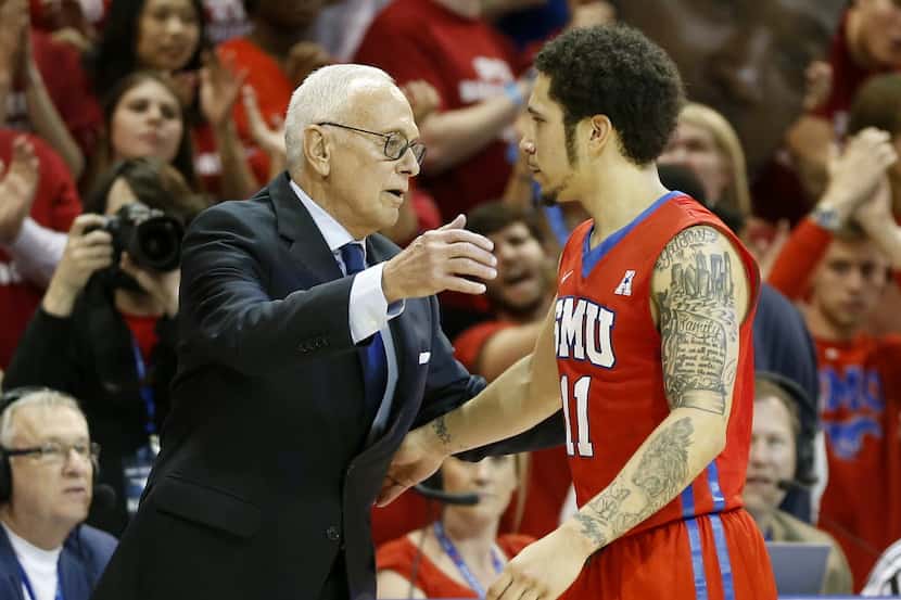 SMU guard Nic Moore (11) hugs head coach Larry Brown during the second half against...