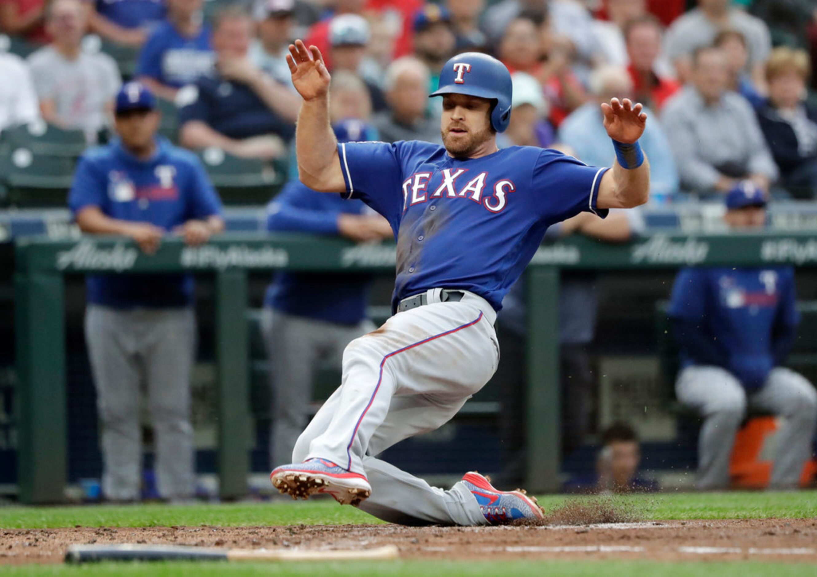 Texas Rangers' Logan Forsythe scores against the Seattle Mariners in the second inning of a...