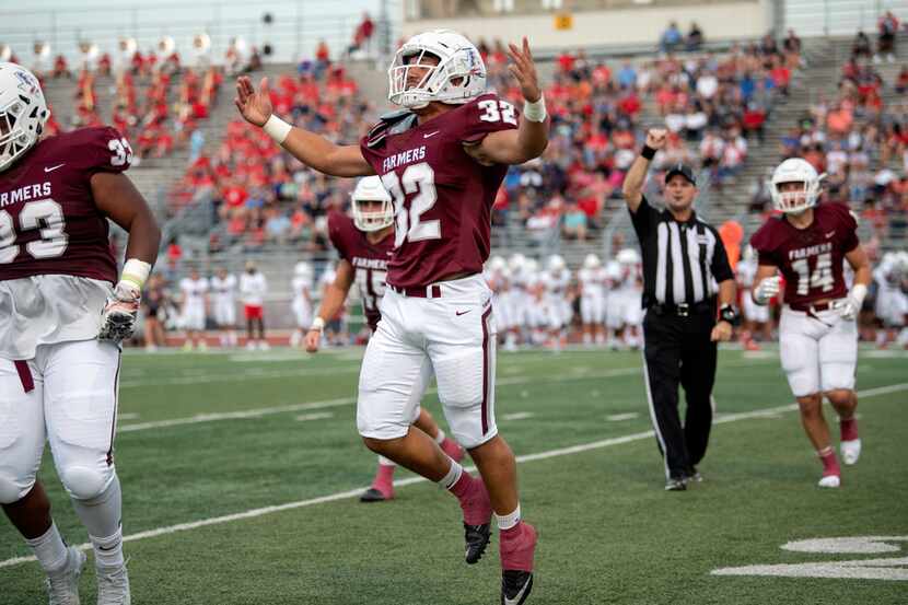 Lewisville senior Earl Barnes (32) celebrates a fumble recovery in the first half of a high...