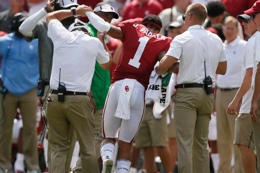 Oklahoma's Jordan Parker (1) is helped off the field after an injury in the first quarter of...