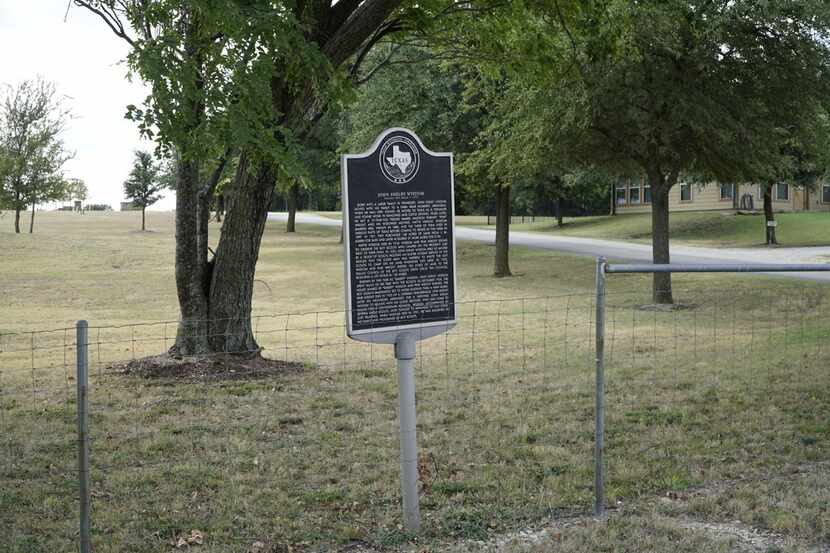A historical marker sits outside the Boy Scouts' Camp Wisdom (which is not on Camp Wisdom...