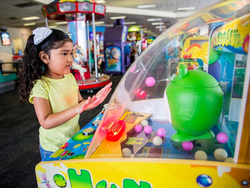 
Alyssa Martinez, 4, of Irving, Texas plays an arcade game at Chuck E Cheese on Wednesday,...