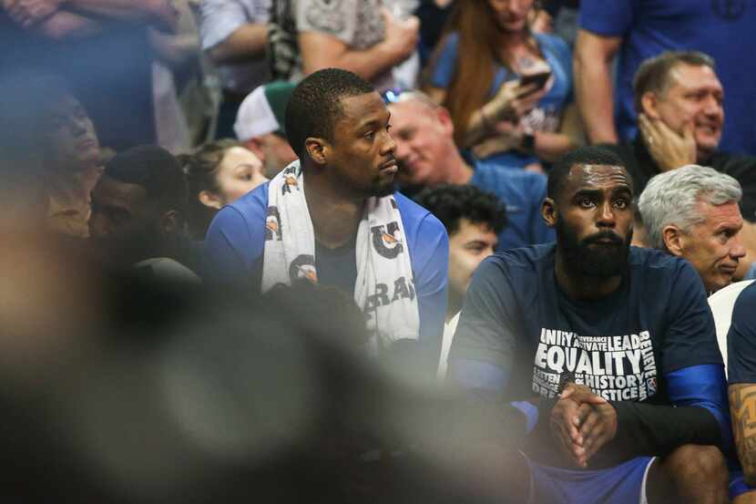 Dallas Mavericks forward Harrison Barnes (40), who was traded during the game, sits next to...