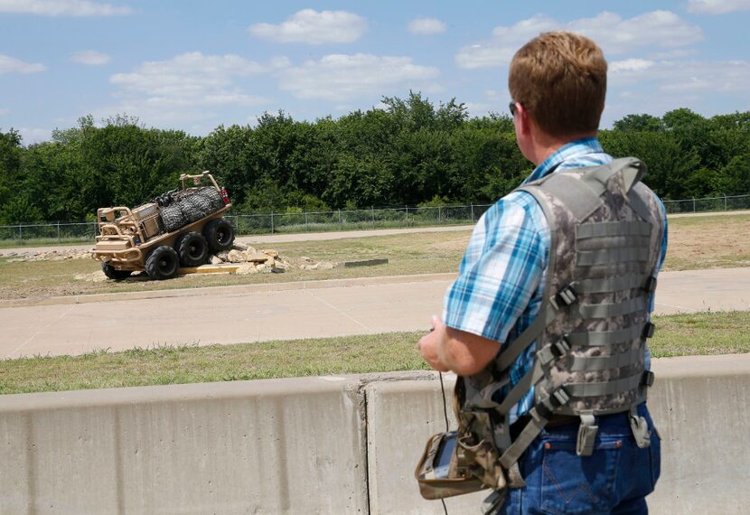 Lockheed Martin mechanical technician Critt Coburn operates a Squad Mission Support System...