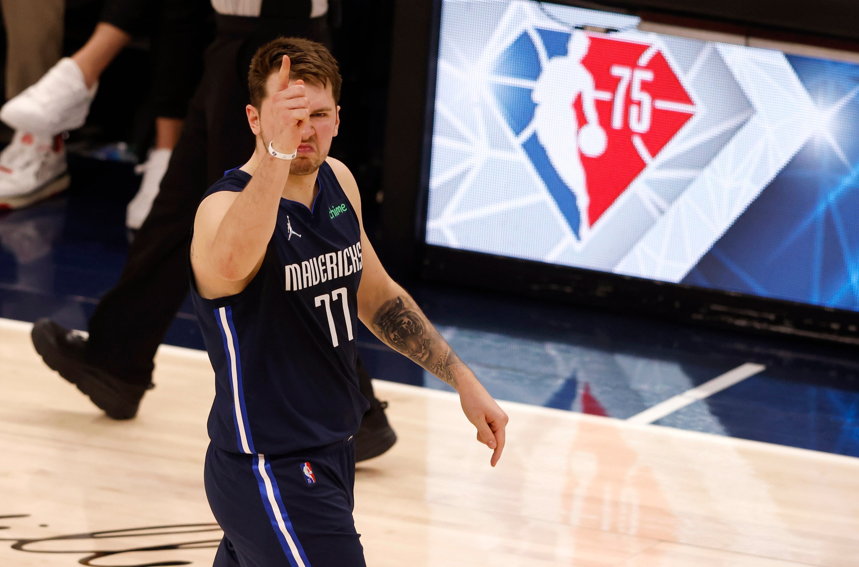 Dallas Mavericks guard Luka Doncic (77) celebrates after making a three pointer in front of...