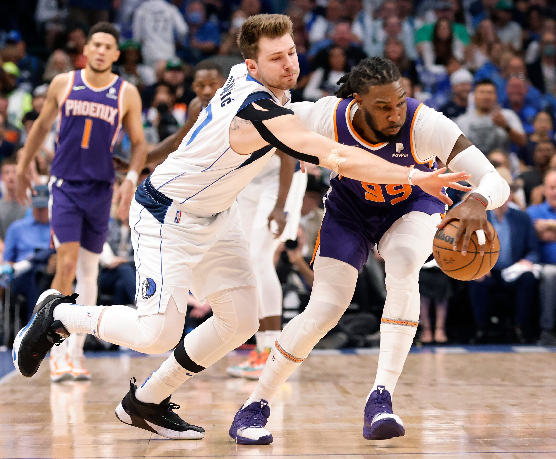 Dallas Mavericks guard Luka Doncic (77) strips the ball from Phoenix Suns forward Jae...