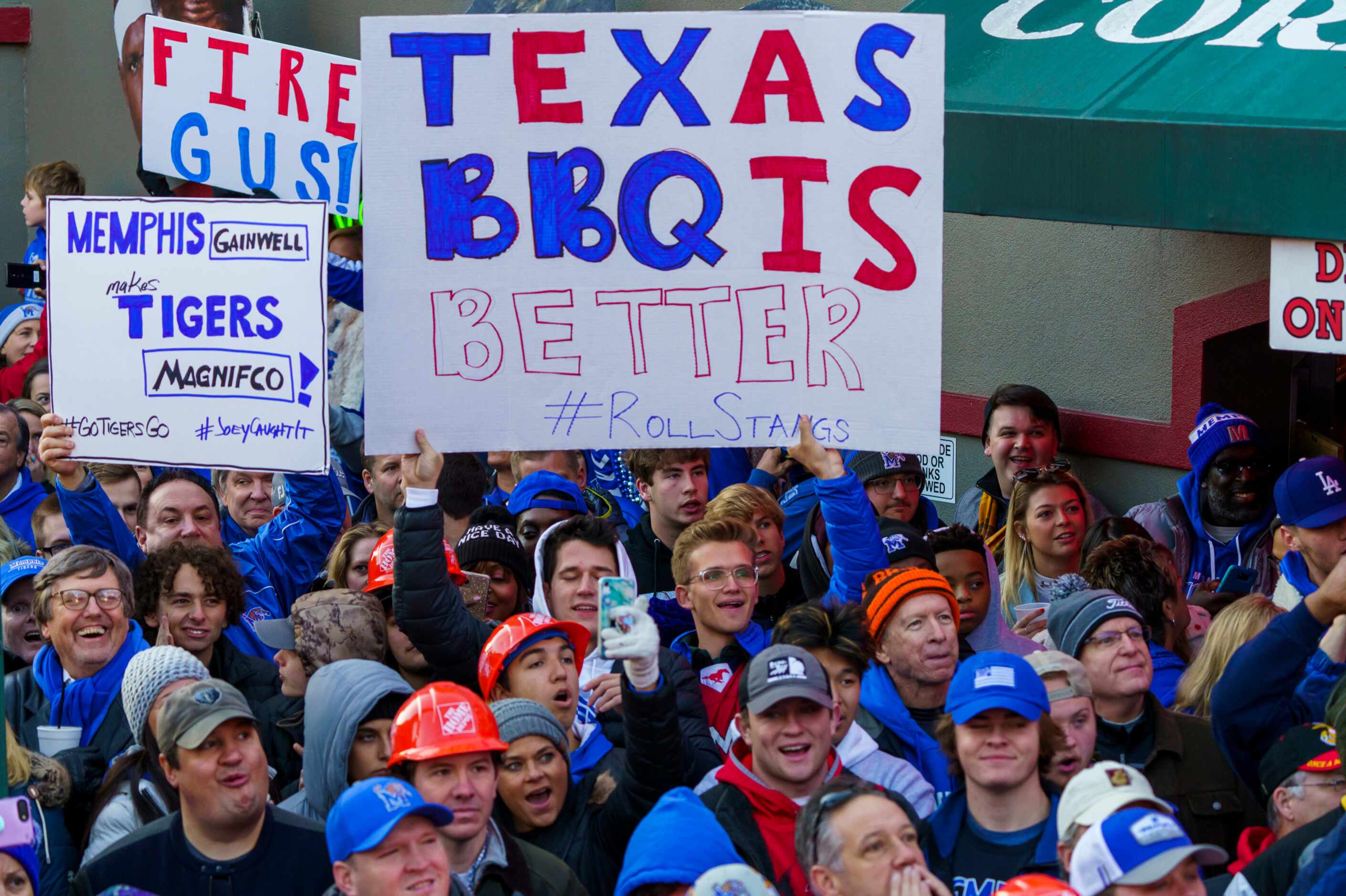 A sign proclaims the superiority of Texas BBQ as SMU fans join the crowd for  ESPN College...