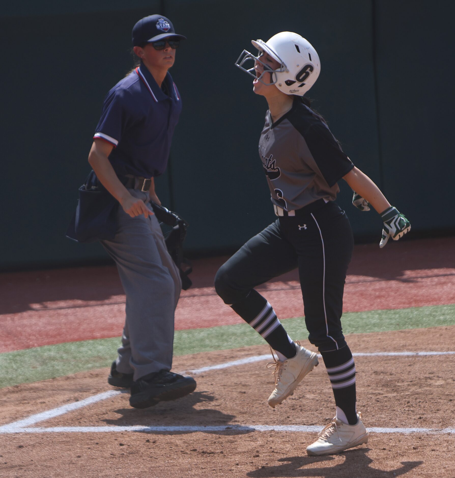 Denton Guyer's Kaylynn Jones (6) lets out a yell after scoring in the top of the first...