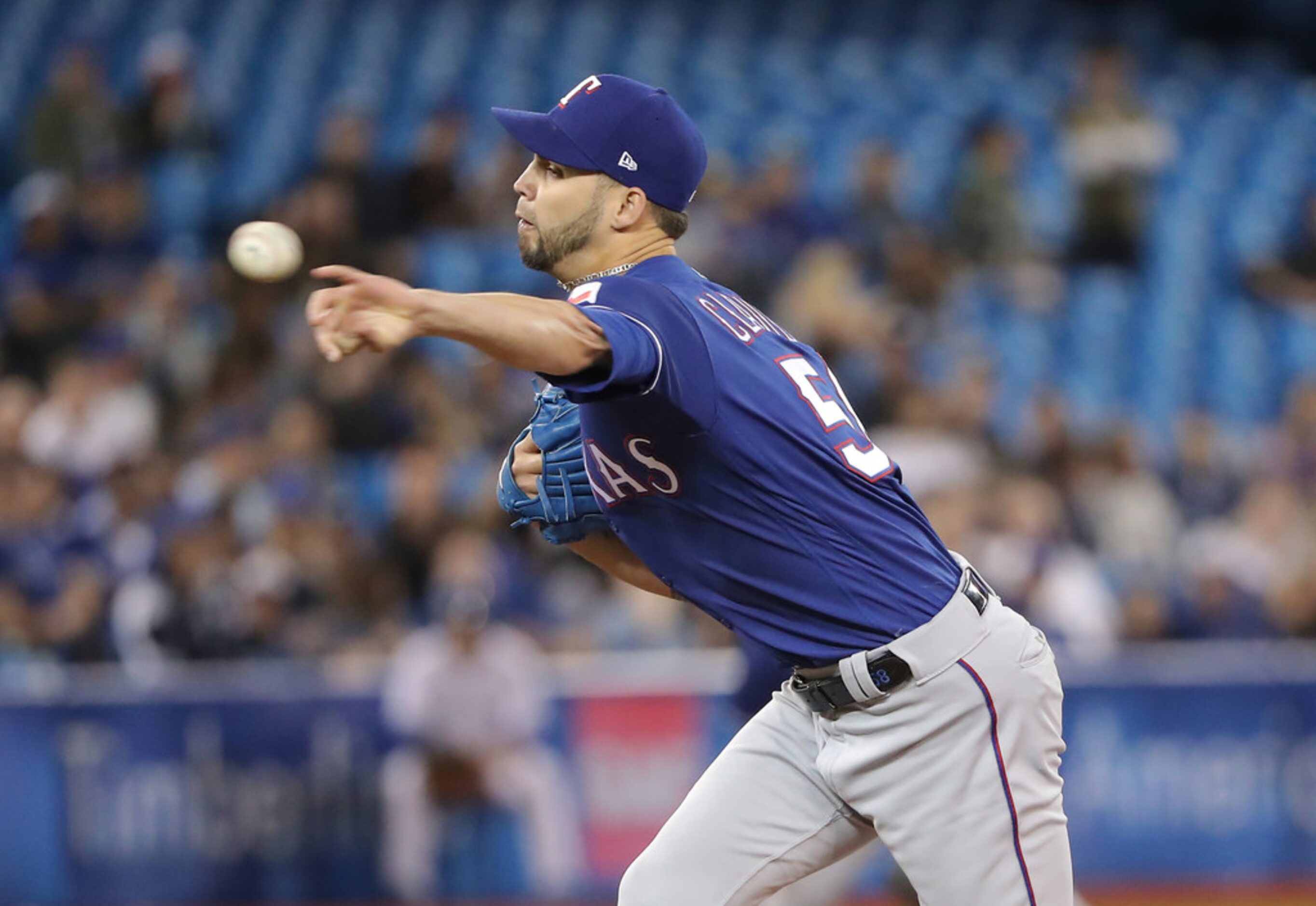 TORONTO, ON - APRIL 27: Alex Claudio #58 of the Texas Rangers delivers a pitch in the...