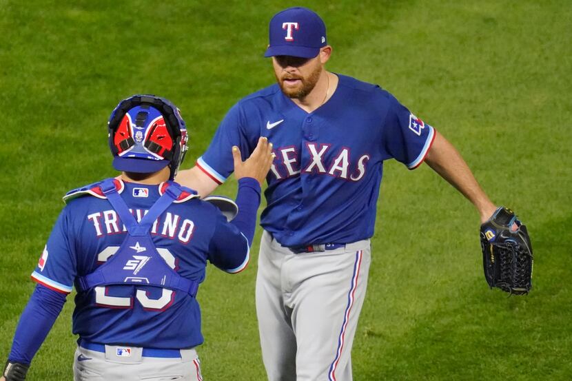 Texas Rangers catcher Jose Trevino, left, and pitcher Ian Kennedy celebrate the Rangers' 6-3...