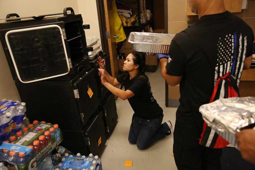 Jennifer Do labels food as she brings order to the kitchen at the Houston Police Officers'...