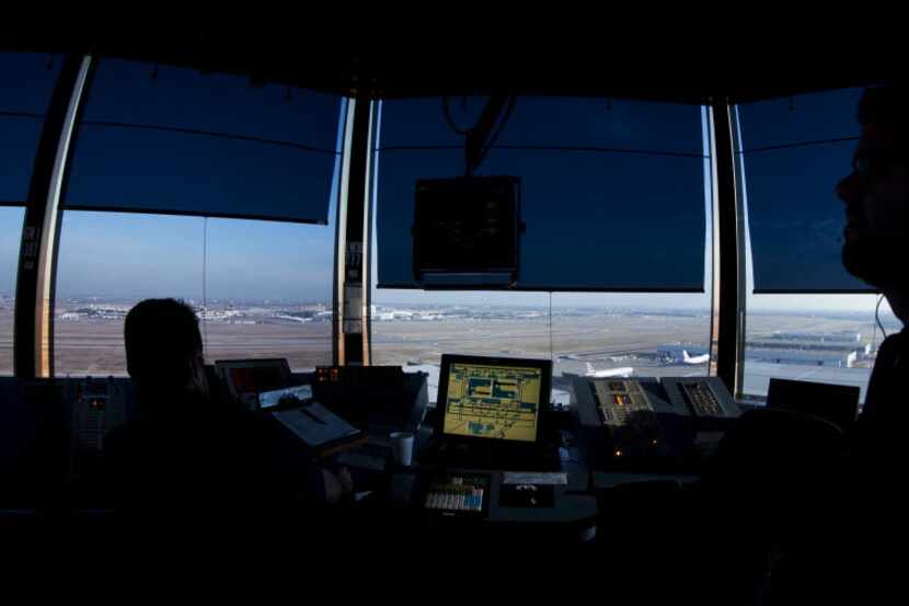 Air traffic controllers work at DFW Airport's west air traffic control tower in Irving. 