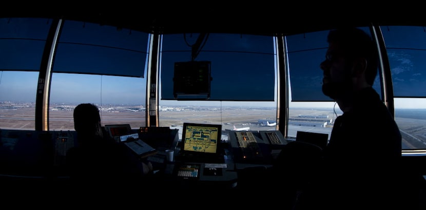 Air traffic controllers work at DFW Airport's west air traffic control tower in Irving. 