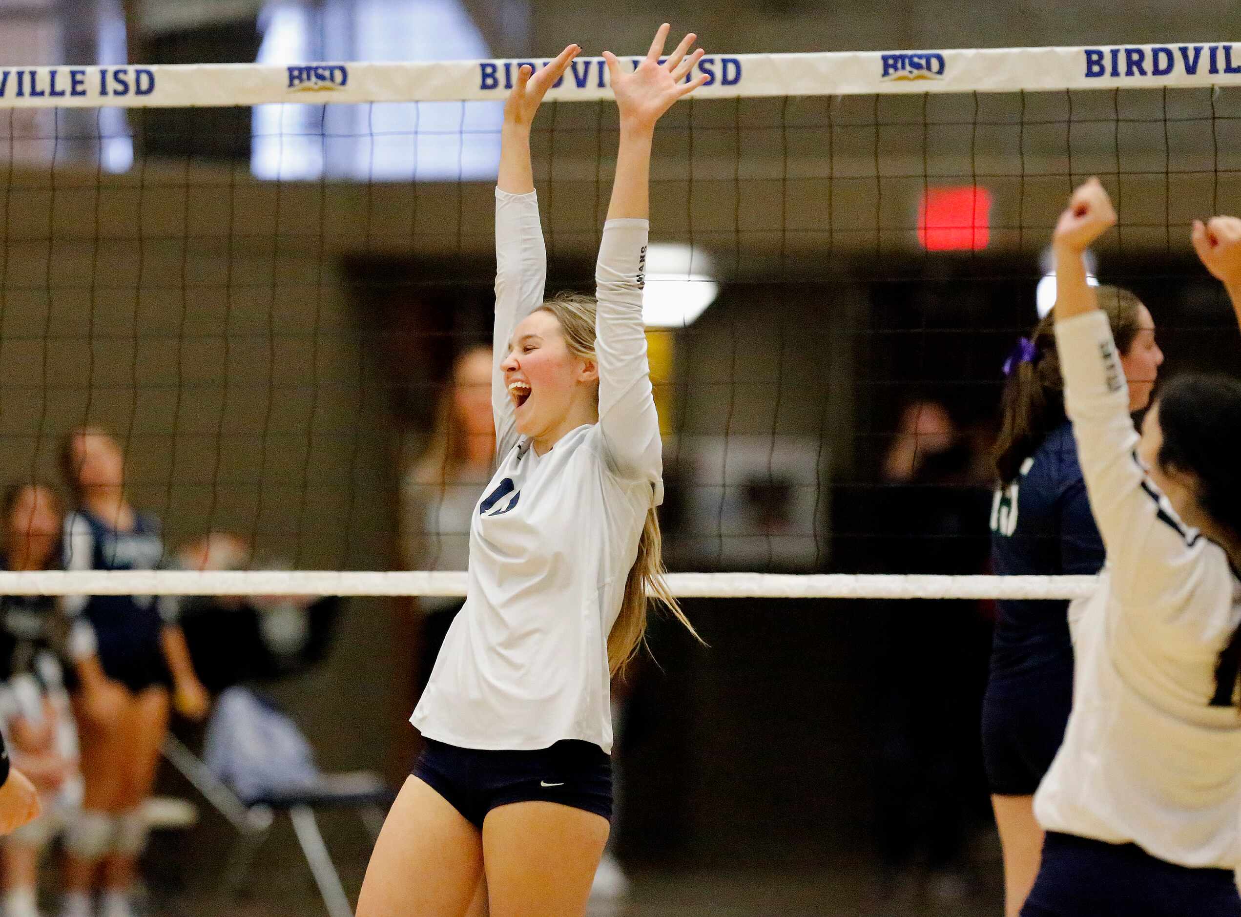 Keller High School middle blocker Jenna Clifford (10) celebrates winning a point in game two...