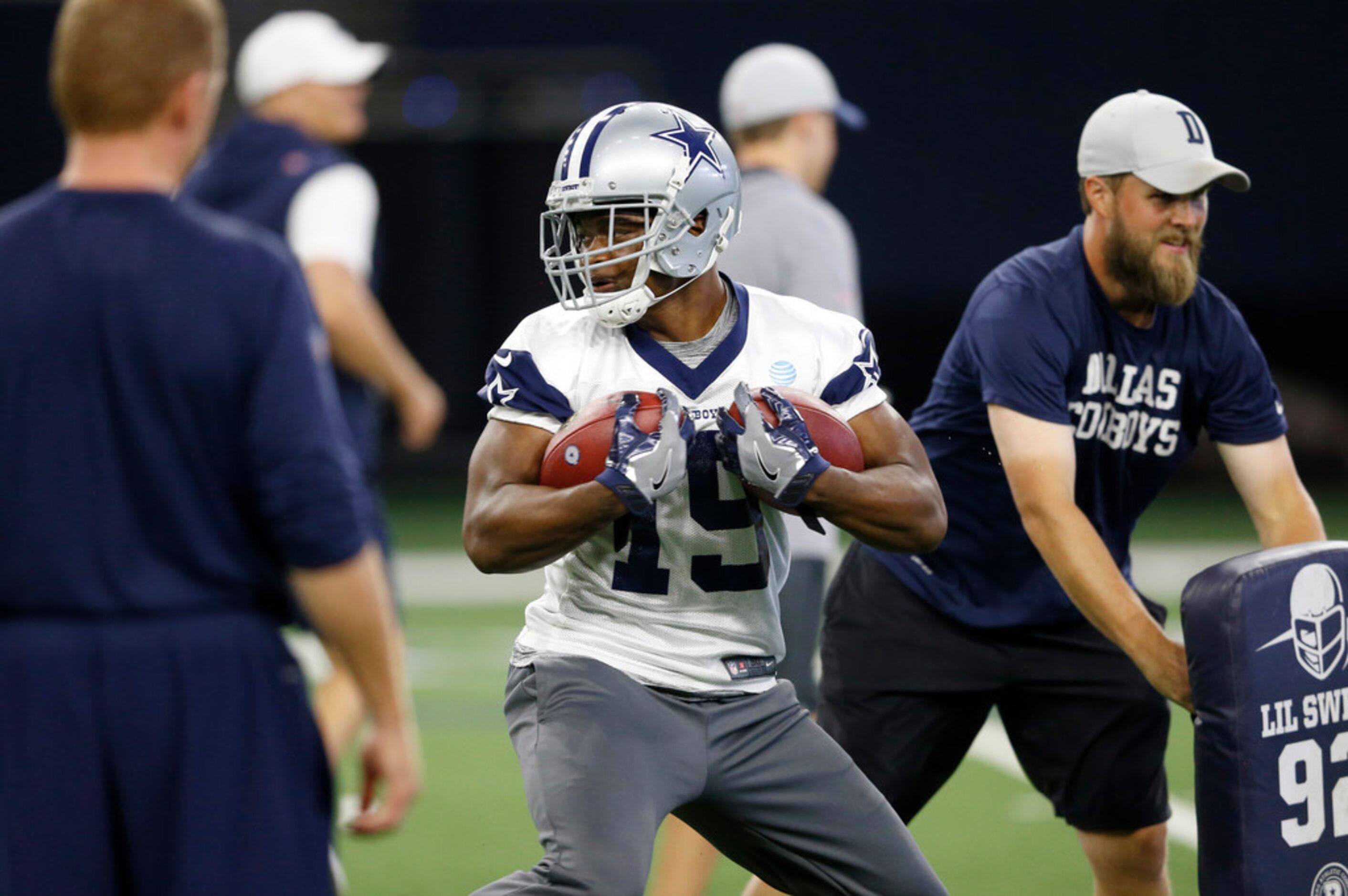 Dallas Cowboys wide receiver Amari Cooper (19) spins as he runs up the in a drill during...