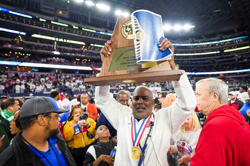 Duncanville head coach Reginald Samples lifts the championship trophy after a victory over...