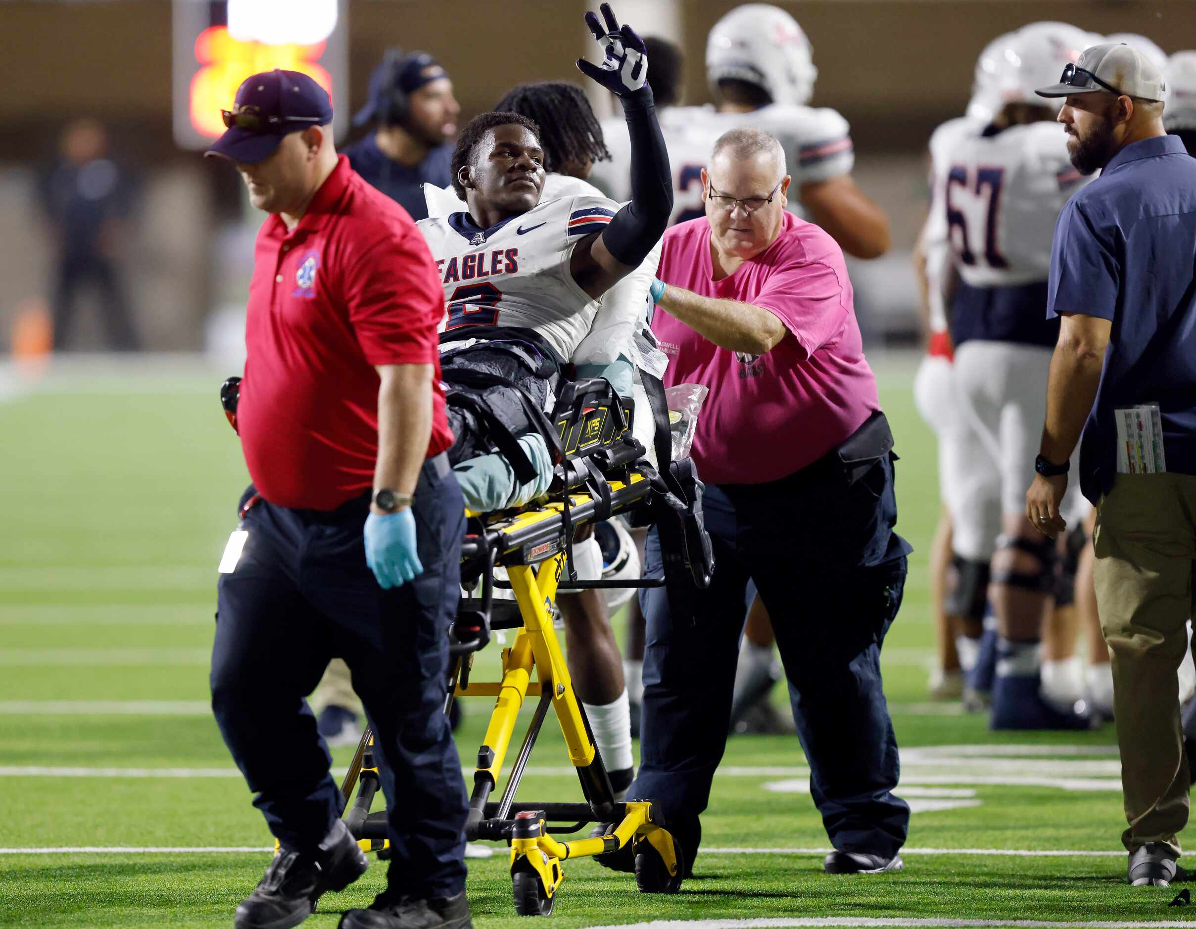 Allen wide receiver Kayvion Sibley (2) raises his hand ass he is carted off the field...