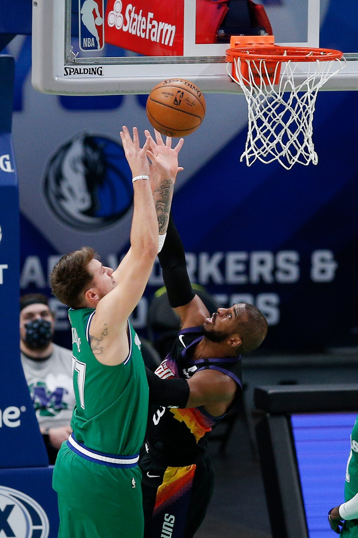 Dallas Mavericks guard Luka Doncic (77) battles Phoenix Suns guard Chris Paul (3) for a...