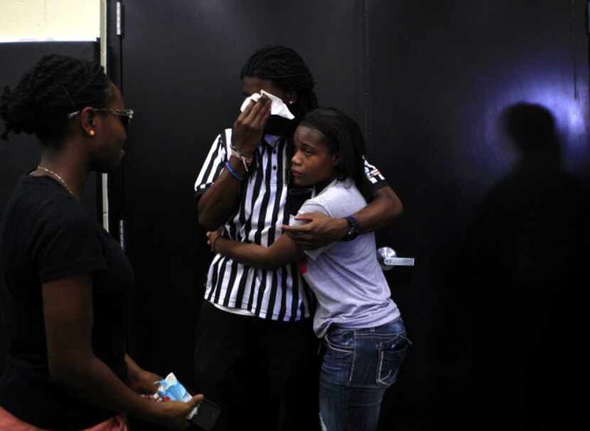 Jaztin Watkins (center), 18, hugged DaNesha Brown, 19, during Tuesday’s memorial service for...