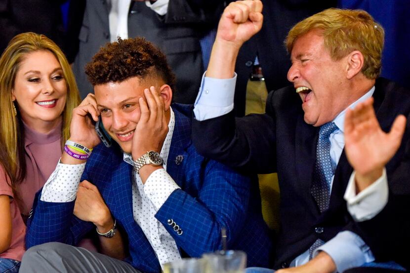 Randi Martin, Patrick Mahomes and Leigh Steinberg react while Mahomes is on a call with the...