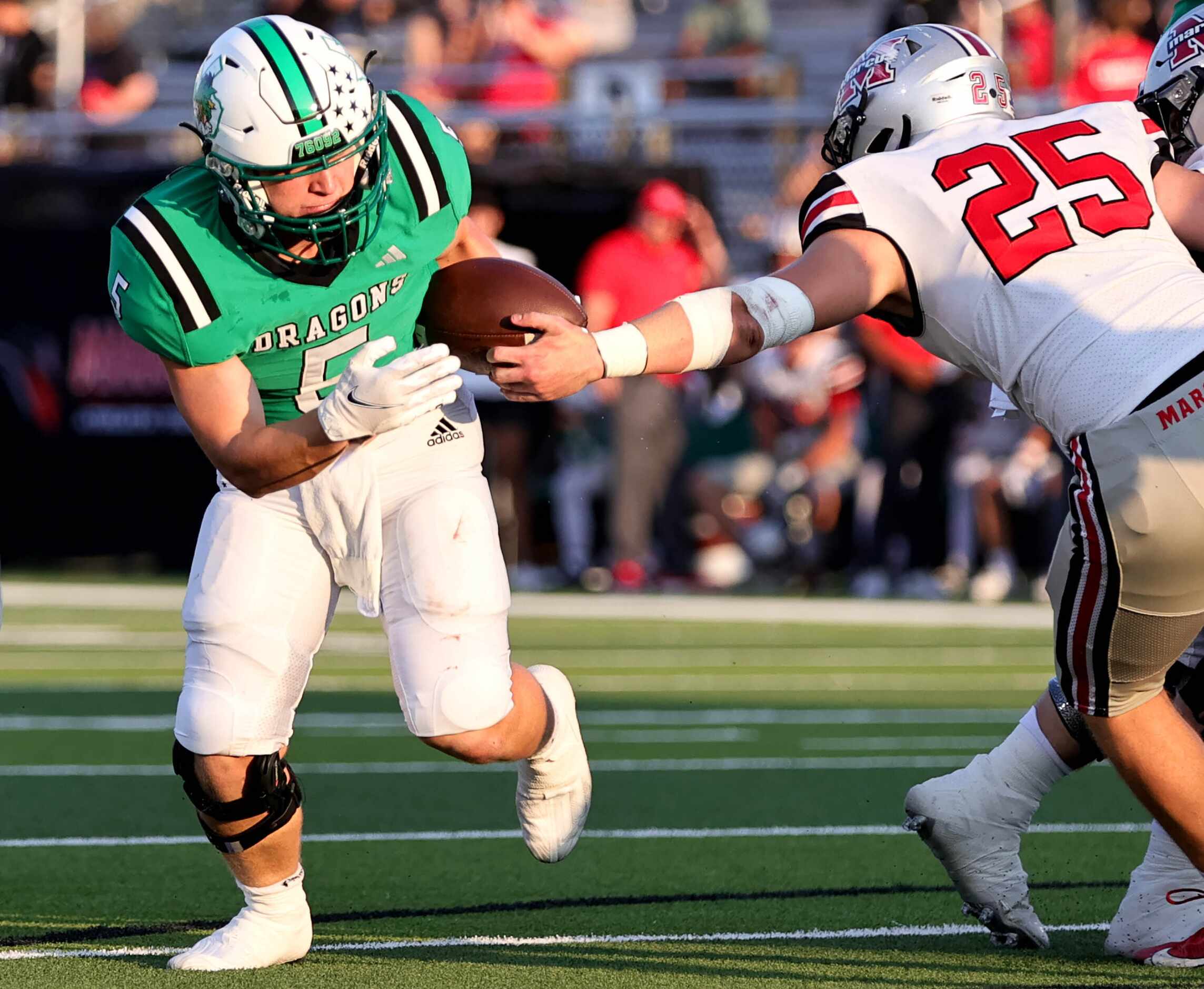 Southlake Carroll running back James Lehman (5) tries to avoid being tackled from Flower...