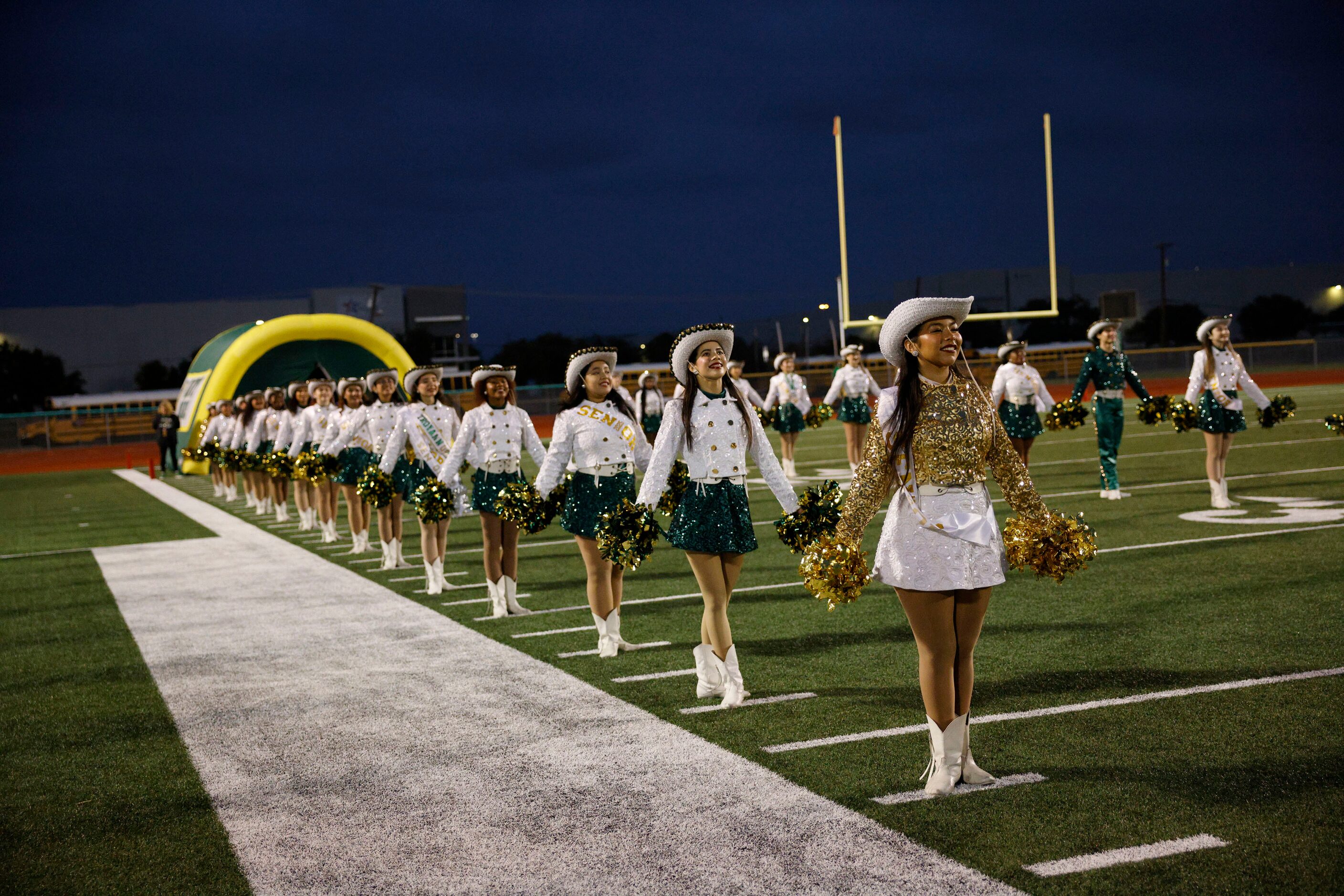 Newman Smith dance team members line up before a high school football game against West...