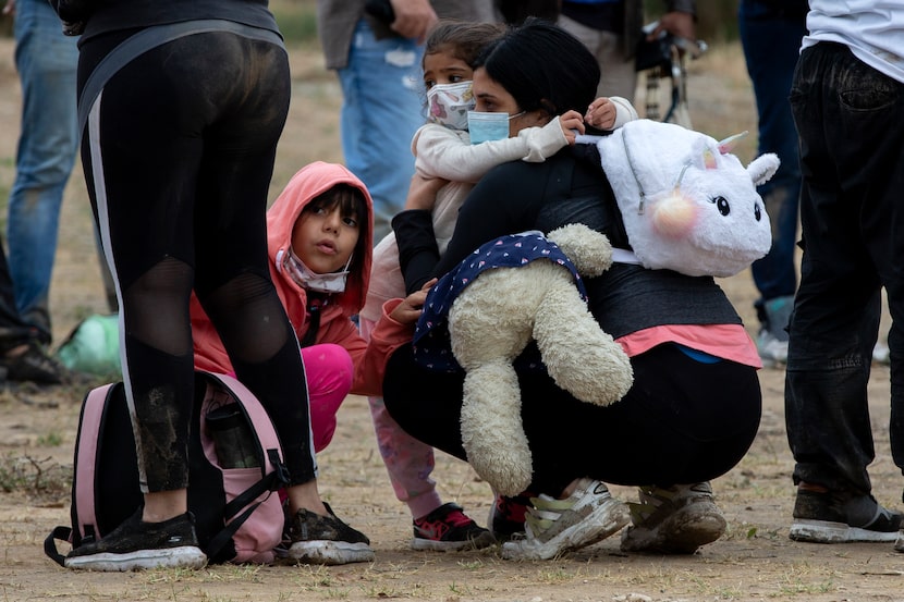 Migrants from Venezuela wait to be processed by U.S. Customs and Border Protection agents...