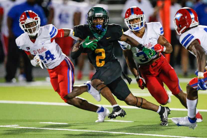 DeSoto senior wide receiver Mike Murphy (2) carries the ball against the Duncanville defense...