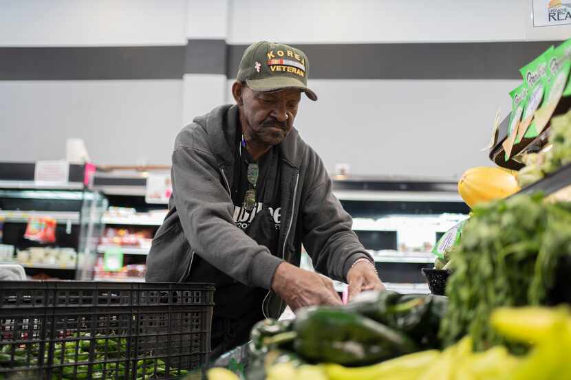 Produce Manager David Daniels stocks vegetables at Jubilee Market, a one-of-a-kind,...